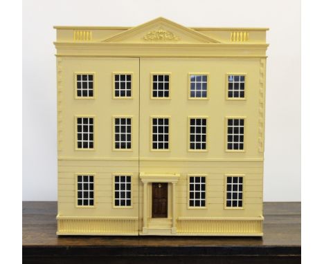 A craftsman built cream Georgian style dolls house, late 20th century, the house with an architectural pediment and balustrad