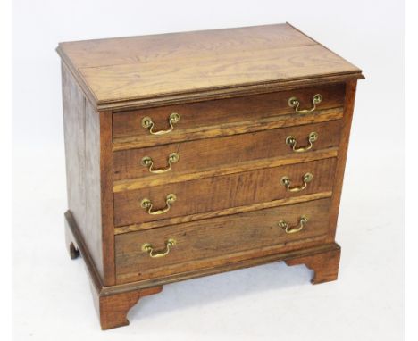 A 19th century honey oak chest of drawers, the rectangular moulded top above four oak lined graduated drawers, applied with b
