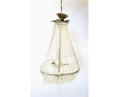 A gilt metal and glass droplet pendant light fitting, of swelling form, the lines of glass droplets enclosing a three branch 