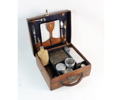 An Asprey leather picnic case and contents, early 20th century, the cover embossed with 'Lady Beatrice Ormsby-Gore', the fitt