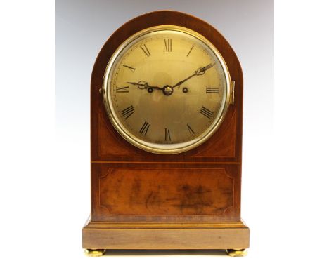 An early 20th century twin fusee mahogany cased bracket clock, the case of arched form with an 18cm silvered dial applied wit