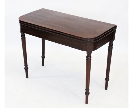 A George III mahogany tea table, the 'D' shaped hinged top raised upon a tapering ring turned cylindrical legs terminating in