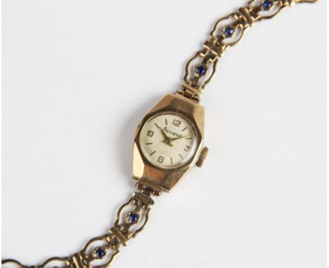 A lady's vintage 9ct gold Accurist wristwatch, the round cream dial with Arabic numerals and baton markers, set to a 9ct gold