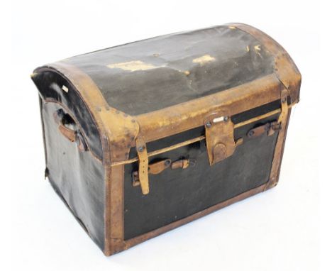 An early 20th century domed canvas and leather trunk, applied with leather banding and straps, opening to a removable tray, 6