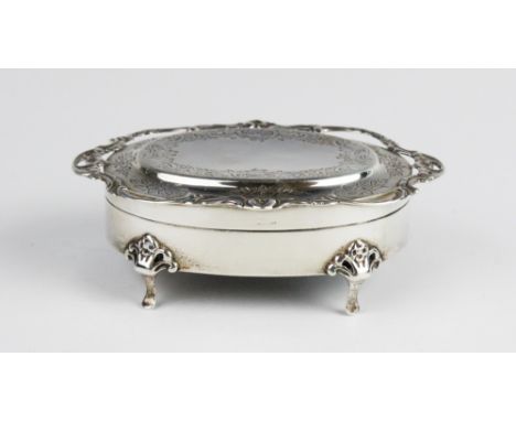 An Edwardian silver trinket box, Birmingham 1907 (maker's mark worn - possibly Henry Matthews), of oval form on four pad feet