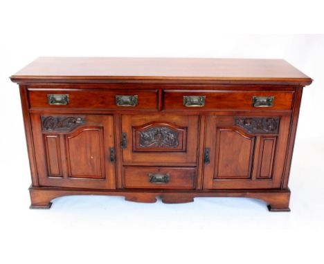 A late Victorian walnut sideboard, the rectangular moulded top above a pair of frieze drawers, applied with Art Nouveau brass