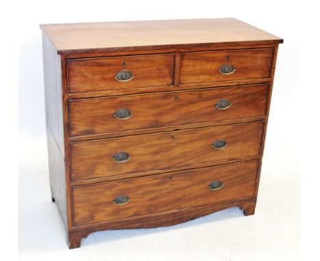 An early 19th century mahogany chest of drawers, with an arrangement of two short and three long graduated and cock beaded dr