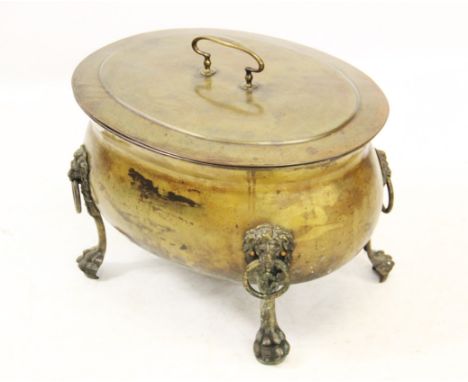A 19th century brass coal or log bin, of oval cauldron form, the removable cover centred with a fixed loop handle, above the 