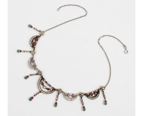 An Edwardian style necklace, of foliate swag form set with untested white sapphires, rubies and green coloured gemstones, all