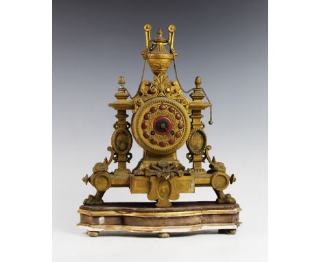 A late 19th century French ormolu mantel clock by Brevete SGDG, with a urn shaped finial above the 9cm gilt metal dial applie