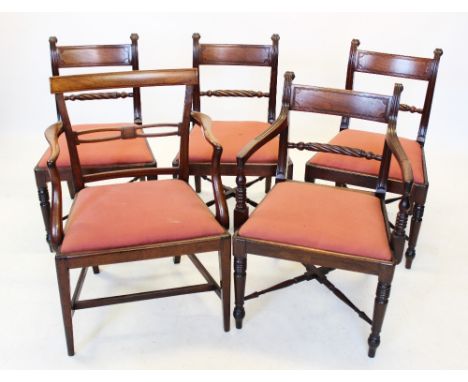 A set of four Regency mahogany dining chairs, each with a rope twist rail above a drop in seat, raised upon front ring turned