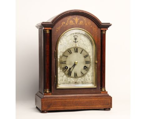 An Edwardian mahogany cased bracket clock, the arched case with tapering pilasters flanking the 13cm break arch silvered dial