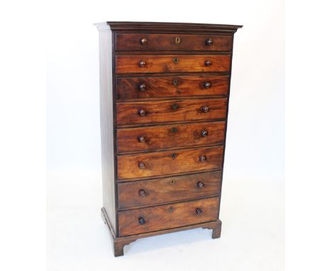A George III tall mahogany chest of drawers, the moulded cornice above eight graduated drawers each with a return moulded edg