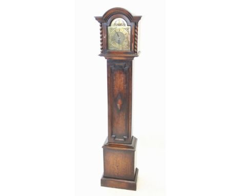 A 1920's oak cased longcase clock, the arched hood with barley twist pilasters flanking the 19cm gilt metal break arch dial e