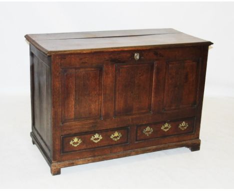 A George III oak and mahogany cross banded mule chest, the rectangular hinged moulded top above three invert moulded panels a