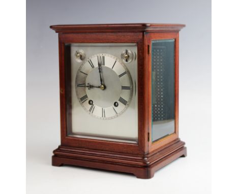 An early 20th century mahogany cased bracket clock, the 15cm silvered dial with subsidiary slow/fast and silent/chime dials, 