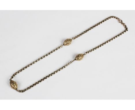 A Victorian necklace, comprising three torpedo-shaped beads with applied decoration, each 16mm x 11mm, set to a yellow metal 