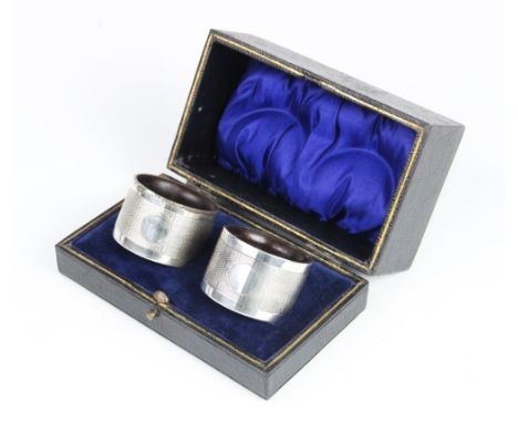 A pair of silver napkin rings by Joseph Gloster Ltd, Birmingham 1934/35, each of circular form with engine turned decoration 