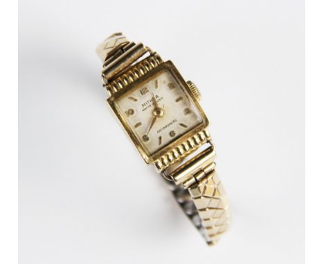 A lady's vintage 18ct gold Mithra wristwatch, the square cream colour dial with Arabic and baton markers, set to an 18ct gold