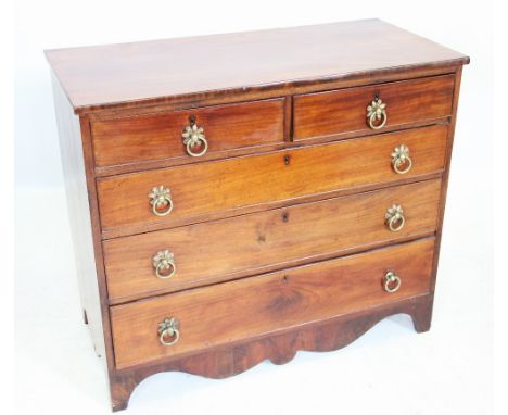An early 19th century mahogany chest of drawers, with an arrangement of two short over three long graduated and cock beaded d
