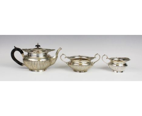 A Victorian three-piece silver tea service by Walker & Hall, Sheffield 1899, comprising teapot, milk jug and sucrier, each of