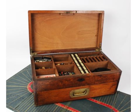 A 19th century mahogany games compendium, the hinged cover centred with an inlaid brass cartouche, opening to a compartmental