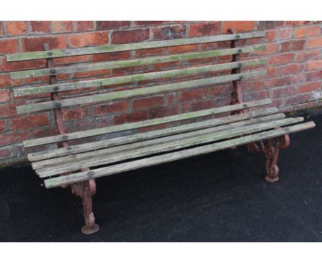 A 19th century cast iron and hardwood garden bench, the pair of cast iron interlaced openwork bench ends united by hardwood s