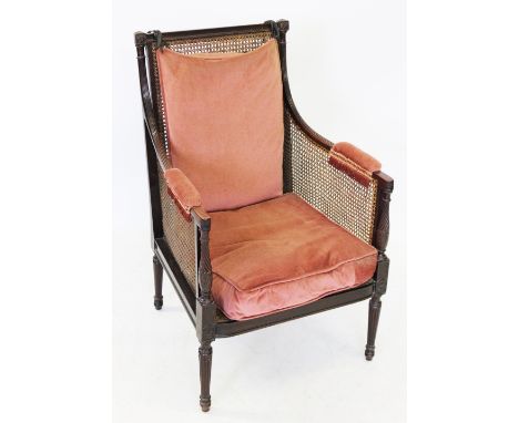 A 19th century mahogany bergere library tub chair, the rectangular rattan back rest flanked by reeded down swept arms, extend