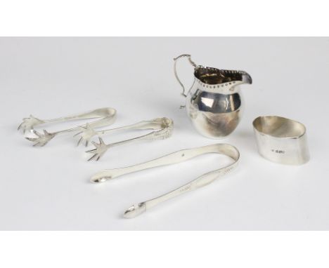 An Edwardian silver cream jug by George Unite, Birmingham 1904, of plain polished baluster form with shaped rim and scroll ha