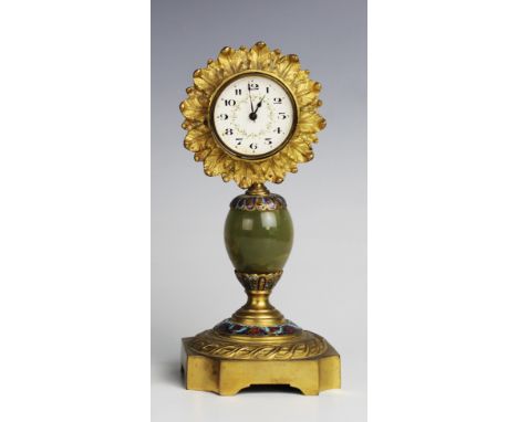 An early 20th century onyx and gilt metal mantel clock, the later 5cm white enamel dial with Arabic numerals, within a leaf c