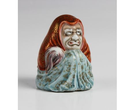 A Japanese Kutani porcelain model of Daruma, Meiji period (1868-1912), the figure of small proportions modelled partially clo