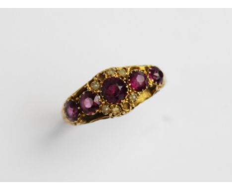 A Victorian amethyst and pearl 15ct gold ring, comprising five graduated mixed cut amethysts (measuring between 3mm and 5mm),