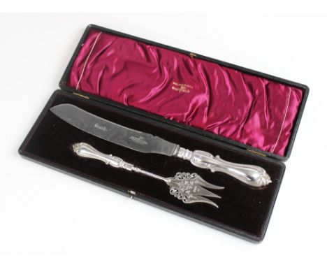 An Edwardian silver handled bread knife and fork by Walker & Hall, Sheffield, both with filled silver Albert pattern handles,