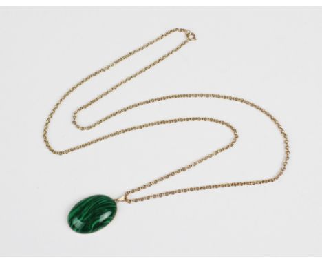 A malachite pendant on chain, the central polished oval malachite cabochon measuring 29mm x 20mm, set to a yellow metal mount