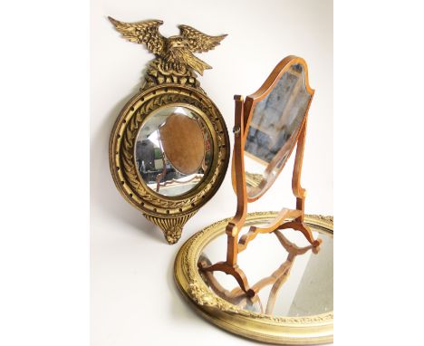 A late 19th century Regency style gilt wood wall mirror, with an eagle crest above the 24cm diameter convex mirrored plate, w