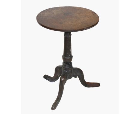 A George III oak tripod table, the circular top on a ring turned tapering column and three down swept supports extending to p