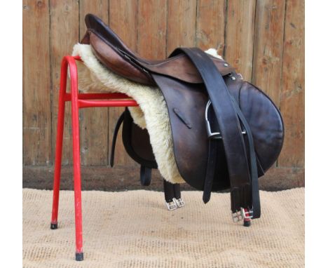 A Holberg 'Spring Seat' leather saddle numbered '3757', 8" wide, 18.5" seat, with associated leathers, stirrups and a three f