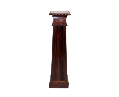 A 19th century and later constructed mahogany pedestal, the square top with a ring turned edge upon a tapering column, applie