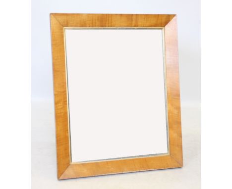A late 19th/early 20th century satinwood rectangular wall mirror, the mirrored plate within a gilt border and plain satinwood