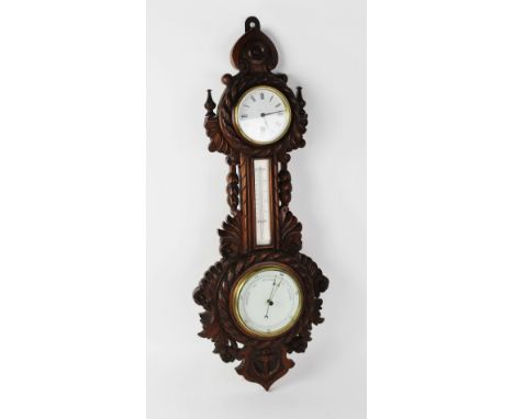 A Victorian carved oak nautical themed barometer and clock combined, the 9cm white enamel clock dial applied with Roman numer