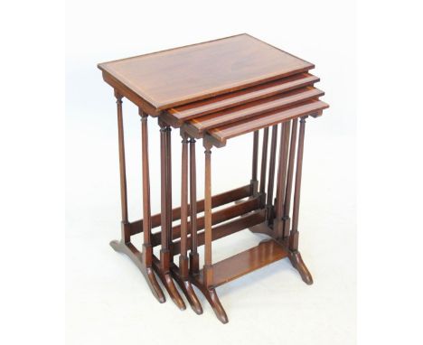 An Edwardian quartetto of mahogany and satinwood crossbanded tea tables, upon slender ring turned legs and down swept support