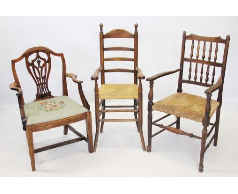 A 19th century oak spindle back elbow chair, with an envelope rush seat on turned legs and plain cross stretchers, along with