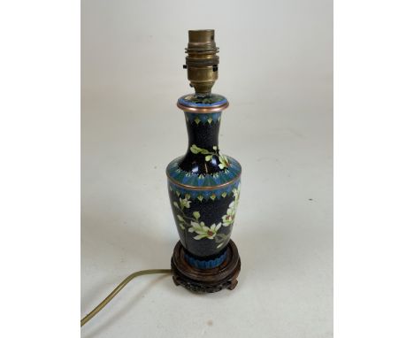 Vintage cloisonné lamp base. Black ground with gold motif pattern, accentuated with flowering tree scenes. Carved circular ba