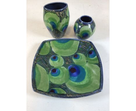 Janice Tchalenko for Dartington pottery, 'Peacock' four sided dish and two vases decorated in blue, green and gold, Dish 26cm