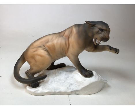 A large Beswick ceramic figure if a puma on rocks W:31cm x H:22cm