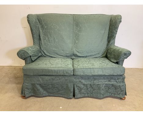 A Parker knoll semi wing back two seater sofa. MK3 model.W:130cm x D:80cm x H:94cm