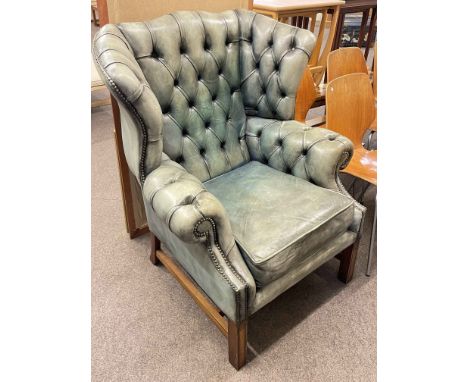 Deep buttoned and brass studded leather Georgian style wing armchair, two bevelled wall mirrors and print (4).
