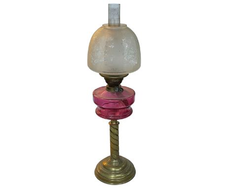Vintage brass twist columned oil lamp with ruby glass reservoir, 71cm.