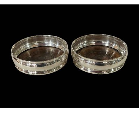 Pair silver wine bottle coasters, London 1966.