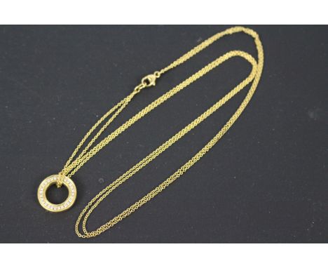 An 18ct yellow gold and diamond Roulette pendant on trace chain by Boodles (46cm length), stamped 750, each side of the penda